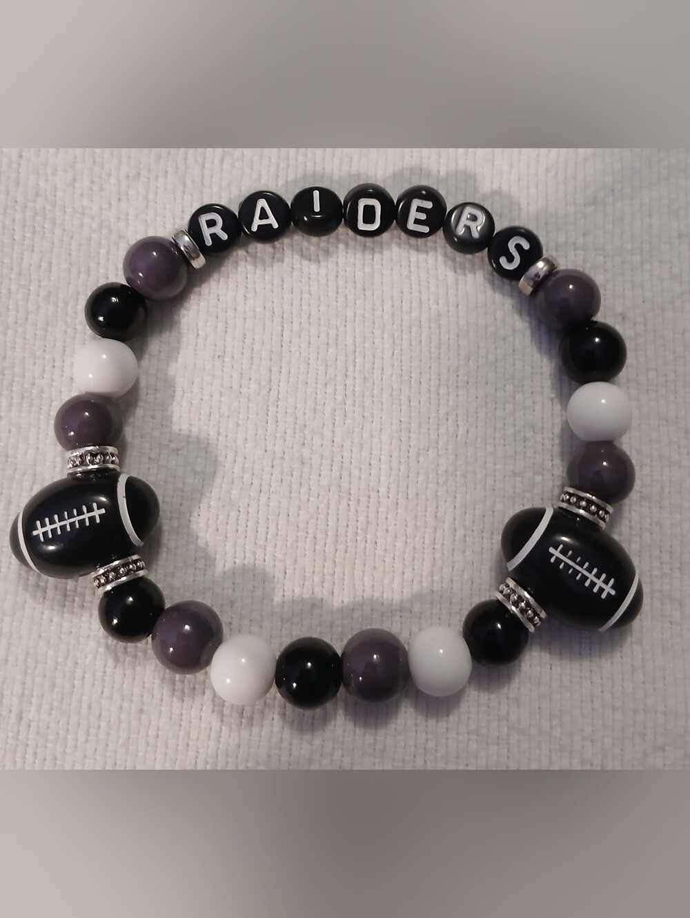 NWT Hancrafted RAIDERS Beaded Stretch Bracelet - Black, White, Gray.